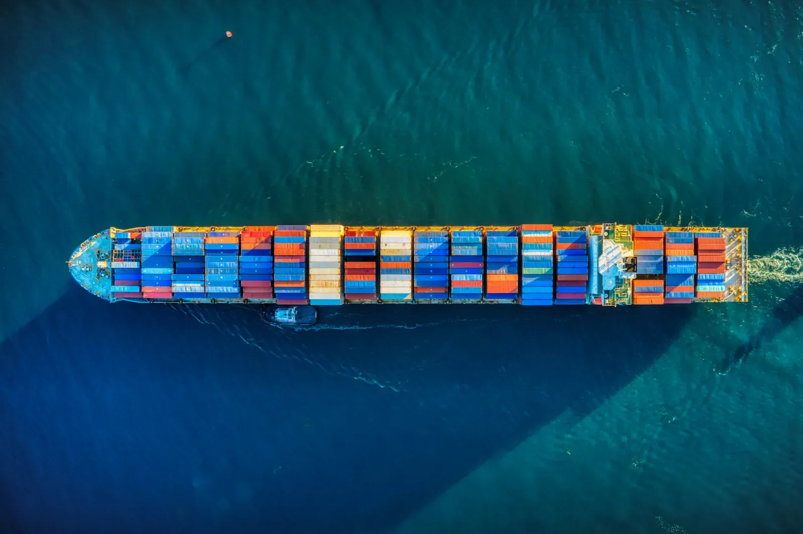 Beladenes Containerschiff von oben auf dem Meer – Symbolbild
